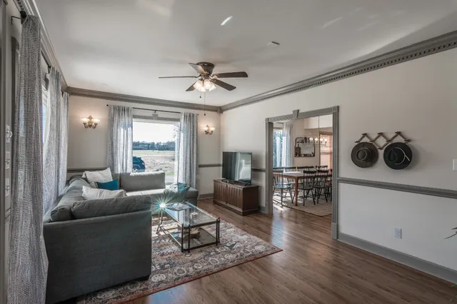 a living room with furniture and a wooden floor