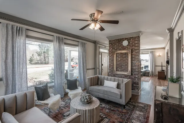 a living room with furniture and a large window