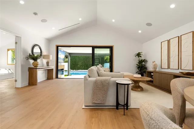 a living room with furniture stove and a large window