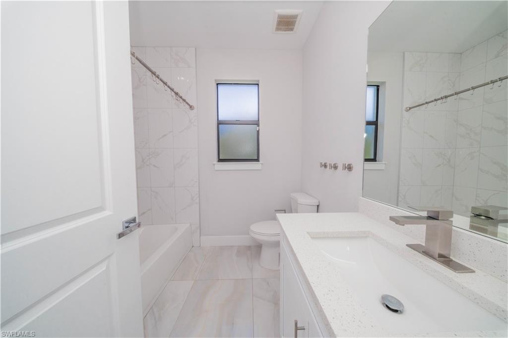 808 37th Avenue Northwest Naples, FL 34120 - Photo 11 of 27 a bathroom with a sink a toilet and shower