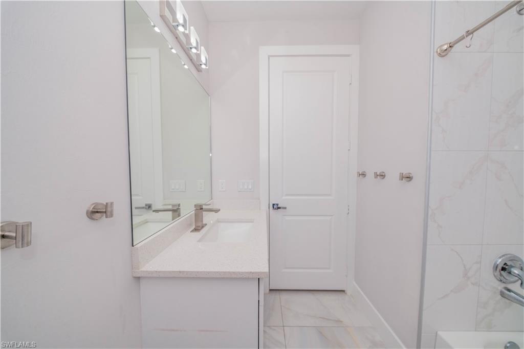 808 37th Avenue Northwest Naples, FL 34120 - Photo 12 of 27 a bathroom with a sink and shower