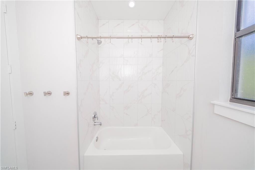 808 37th Avenue Northwest Naples, FL 34120 - Photo 13 of 27 a bathroom with a shower and a bath tub