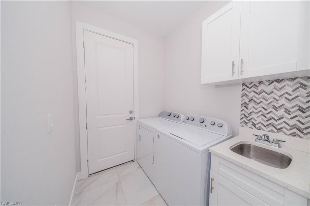 808 37th Avenue Northwest Naples, FL 34120 - Photo 14 of 27 a view of a storage and utility room with washer and dryer