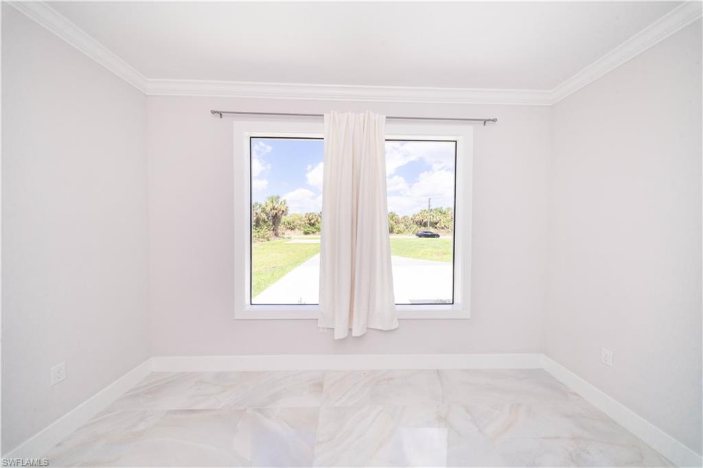 808 37th Avenue Northwest Naples, FL 34120 - Photo 16 of 27 an empty room with windows