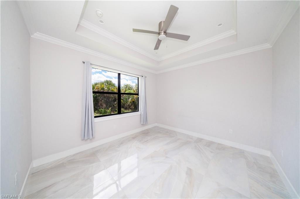808 37th Avenue Northwest Naples, FL 34120 - Photo 17 of 27 a view of room with ceiling fan and window