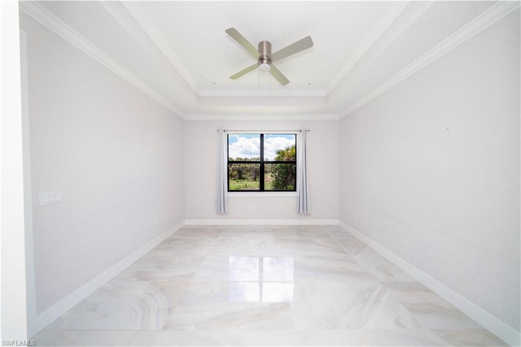 808 37th Avenue Northwest Naples, FL 34120 - Photo 18 of 27 an empty room with windows and ceiling fan