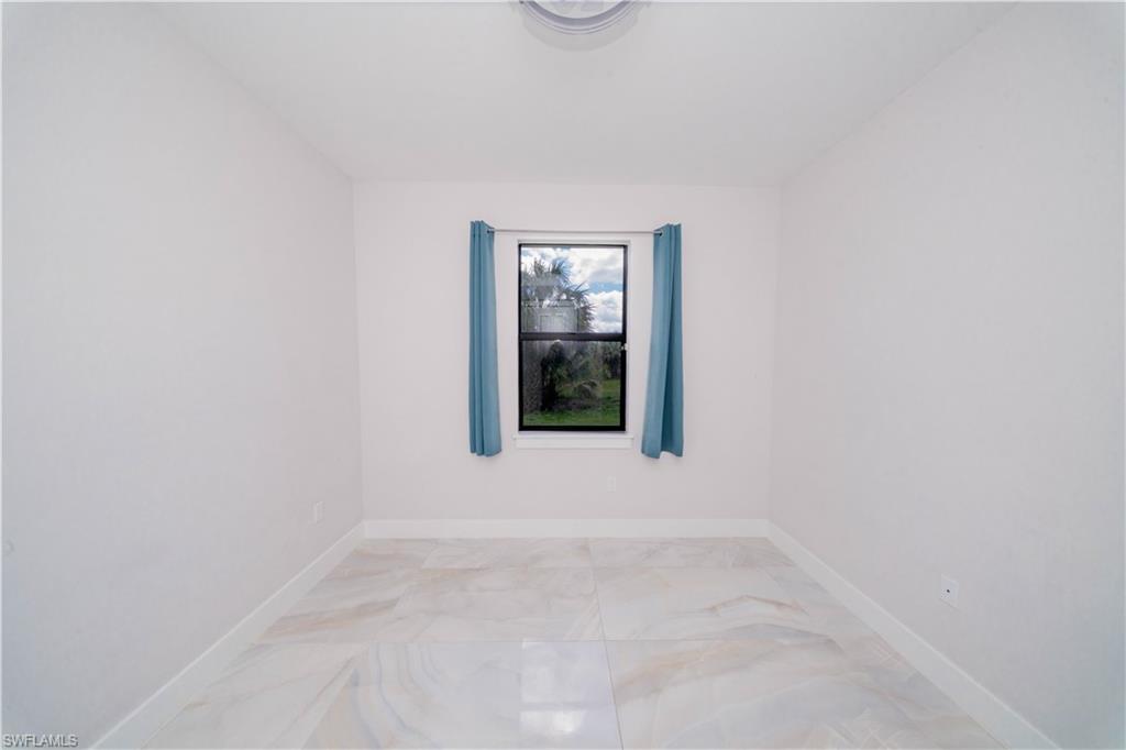 808 37th Avenue Northwest Naples, FL 34120 - Photo 19 of 27 a view of an empty room with a window