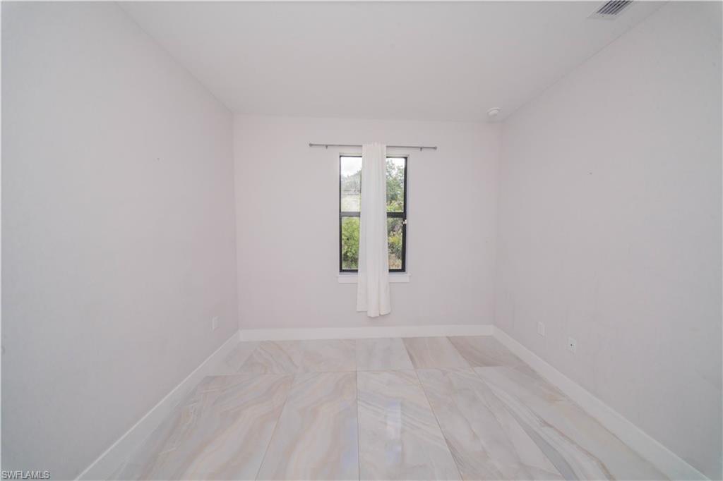 808 37th Avenue Northwest Naples, FL 34120 - Photo 20 of 27 wooden floor in an empty room