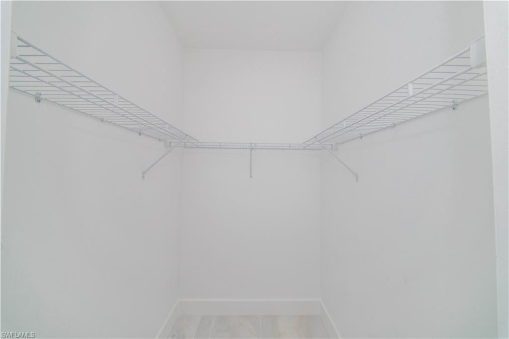 808 37th Avenue Northwest Naples, FL 34120 - Photo 23 of 27 a view of small space with racks on the wall