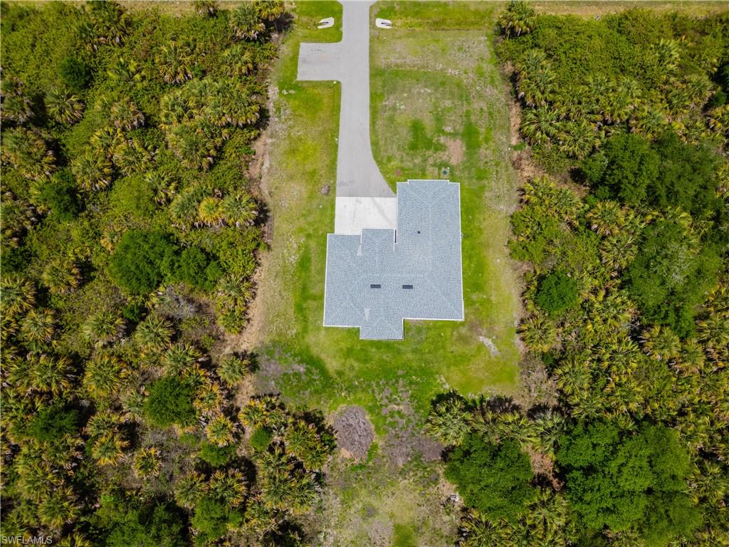 808 37th Avenue Northwest Naples, FL 34120 - Photo 25 of 27 an aerial view of a house with a yard and large trees