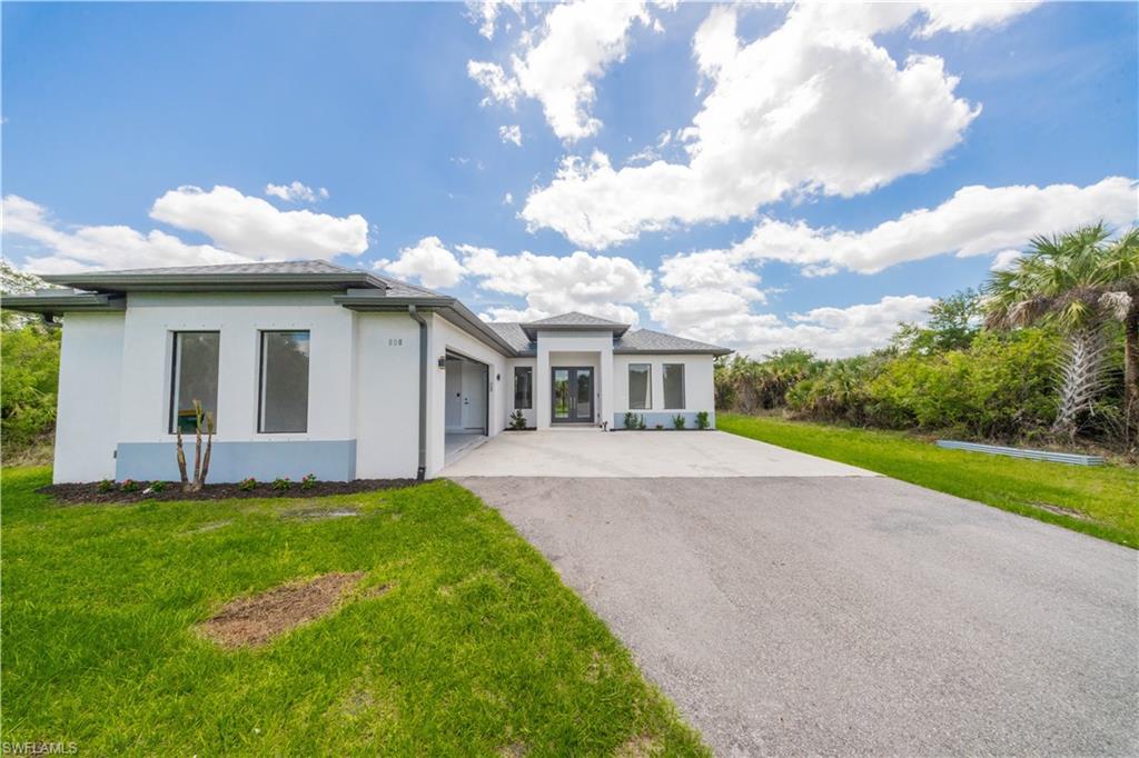 808 37th Avenue Northwest Naples, FL 34120 - Photo 5 of 27 a view of a house with a yard and pathway