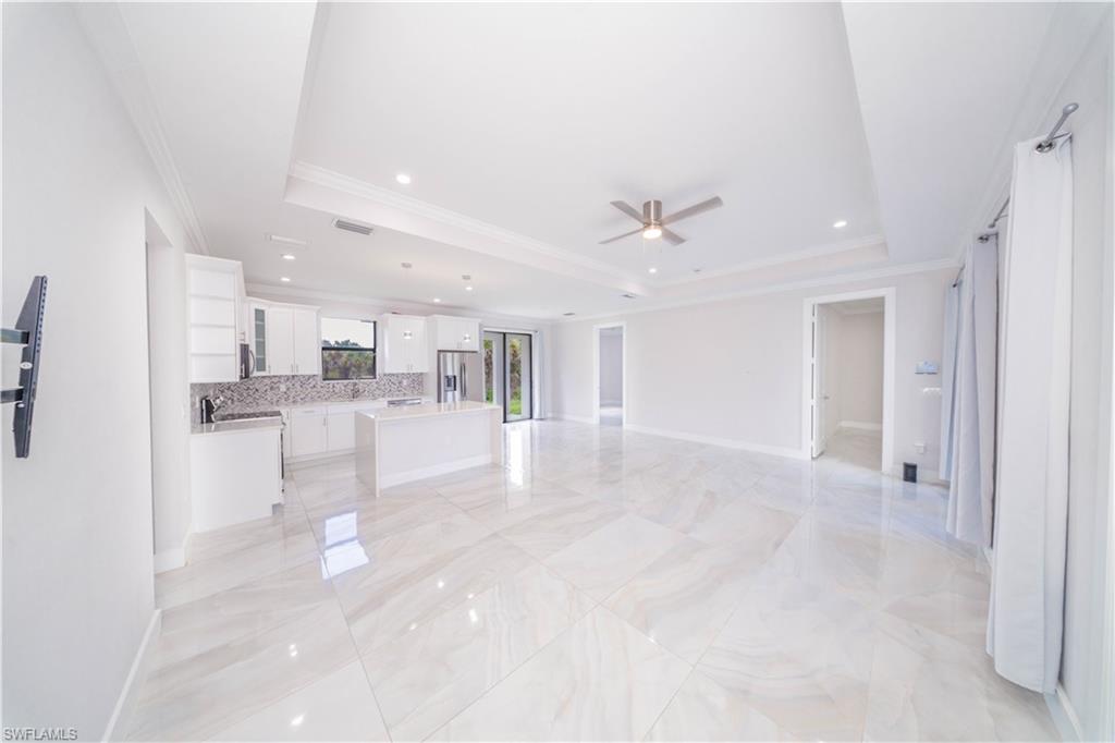 808 37th Avenue Northwest Naples, FL 34120 - Photo 8 of 27 a view of a living room and kitchen with a sink