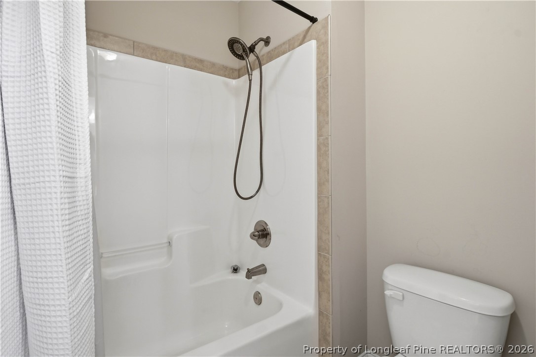 140 Birch Avenue Spring Lake, NC 28390 - Photo 34 of 49 a bathroom with a toilet and a shower