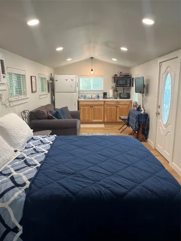 a living room with furniture and kitchen view