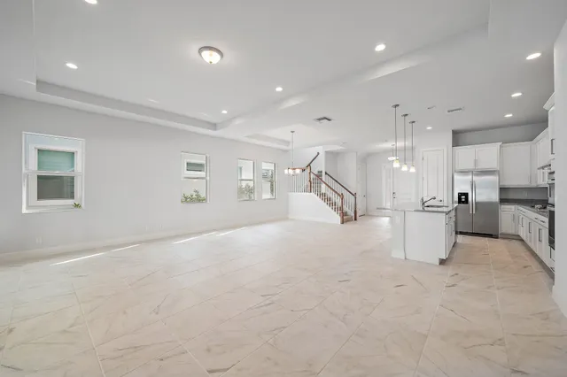 a spacious bathroom with a granite countertop sink and a bathtub