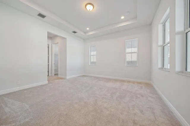 a large bathroom with a large tub sink vanity granite and a mirror