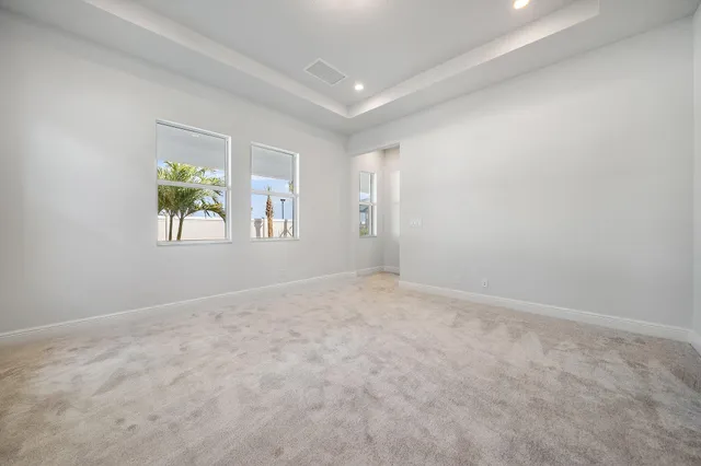 an empty room with a empty space and windows