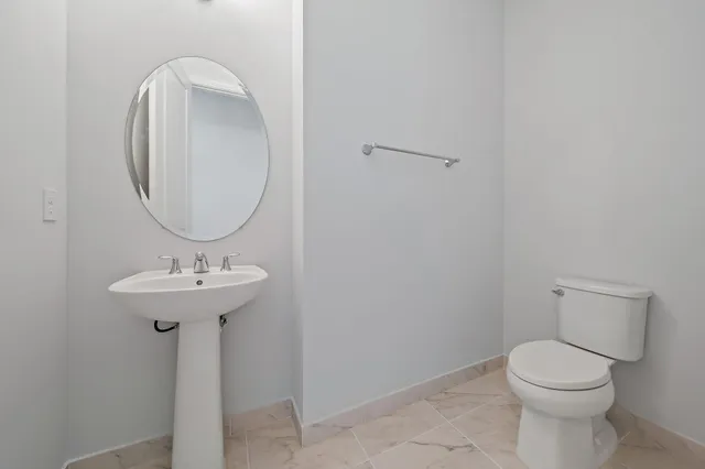 a bathroom with a granite countertop sink a toilet and bathtub