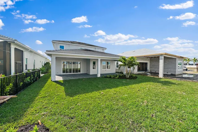 a view of a house with a backyard