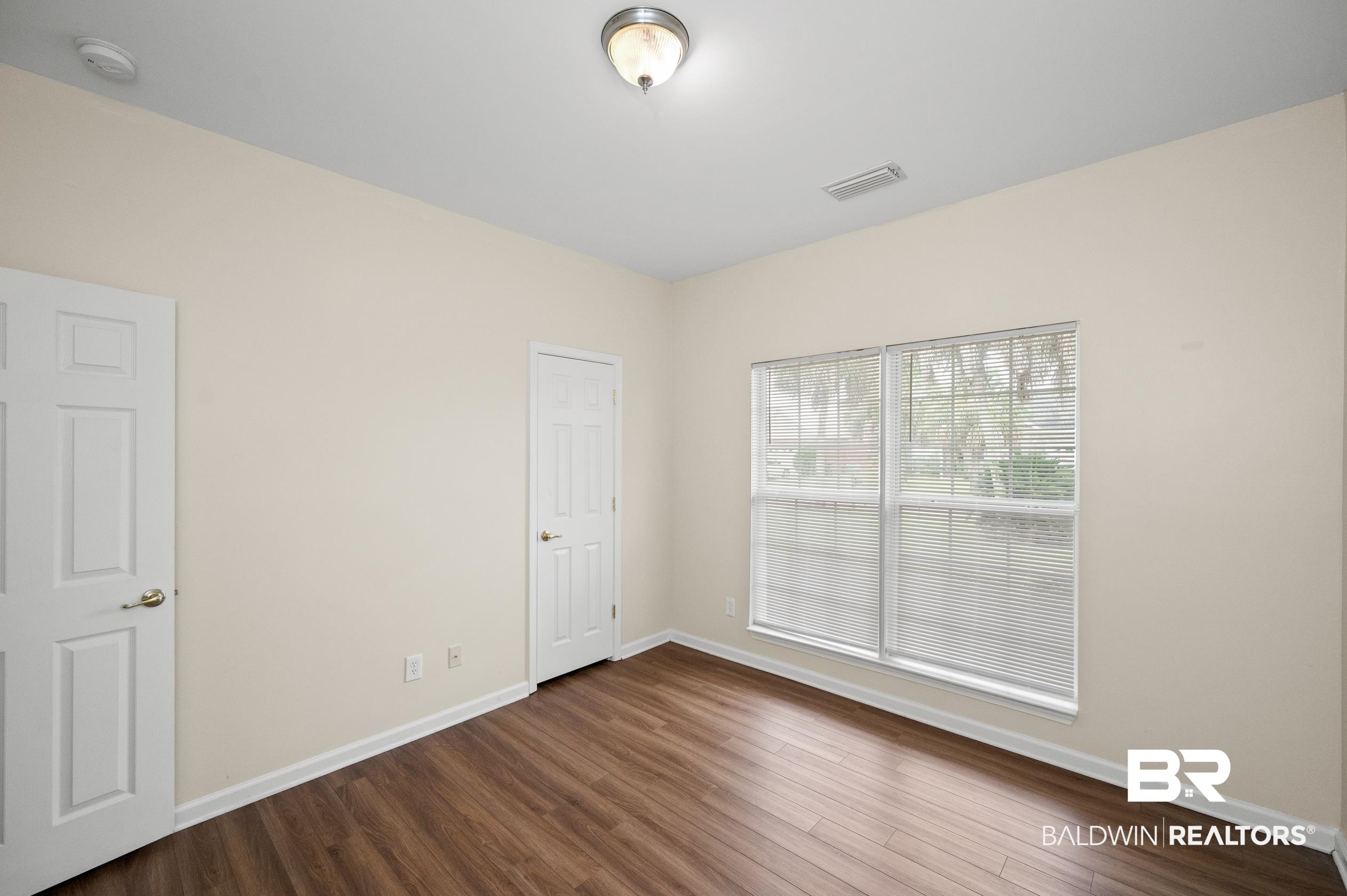 1333 Dominoe Trail Foley, AL 36535 - Photo 19 of 32 Empty room featuring dark wood-type flooring