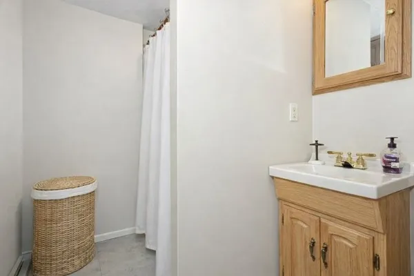 a bathroom with a sink a toilet and a mirror