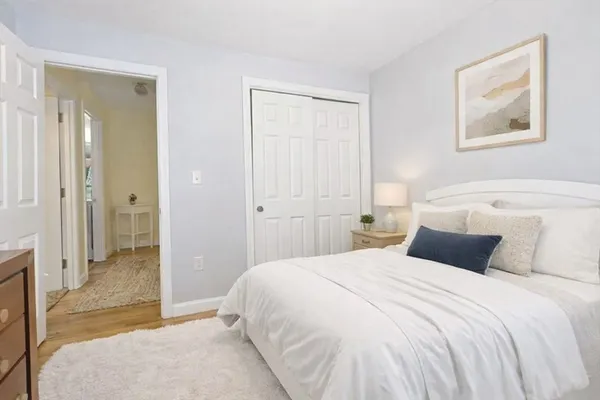a bedroom with a large bed and a chandelier