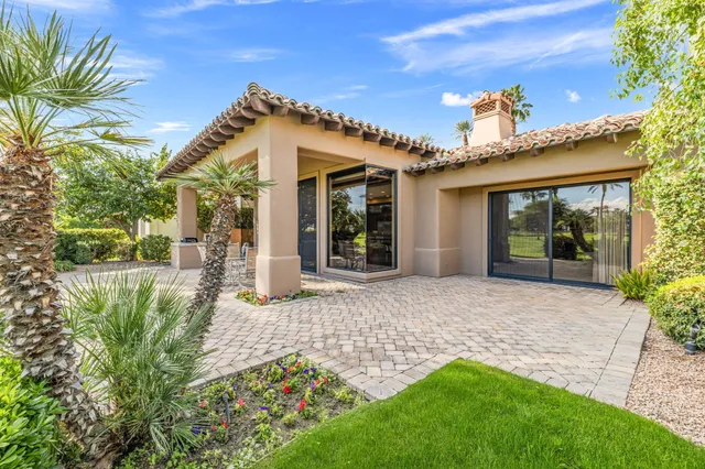 a view of a house with a yard balcony and sitting area