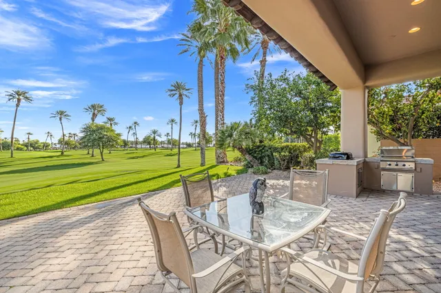 a view of a patio with a table and chairs