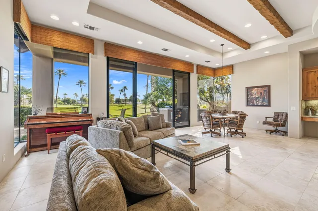 a view of a porch with a table and chairs