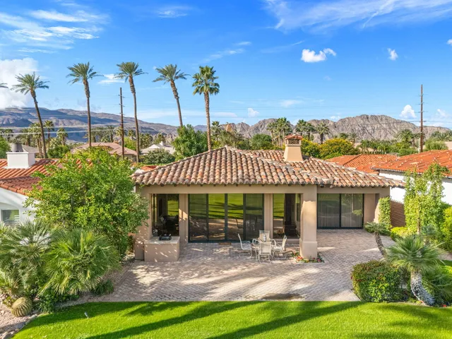 a dining room with furniture and a floor to ceiling window