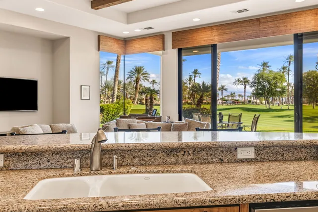 a kitchen with stainless steel appliances granite countertop a stove and a sink