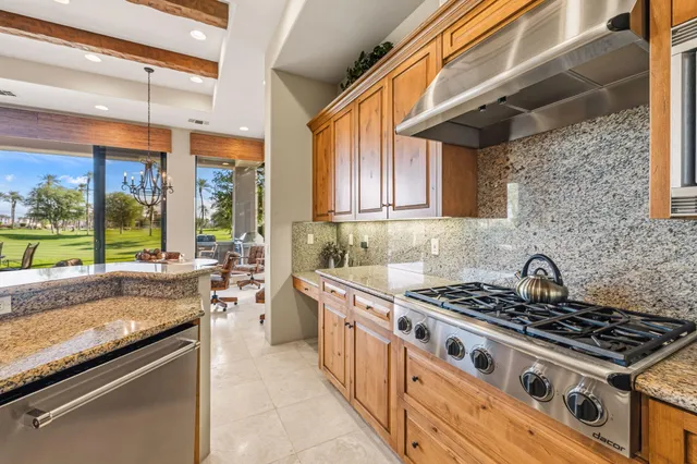 a kitchen with stainless steel appliances kitchen island granite countertop a sink and cabinets