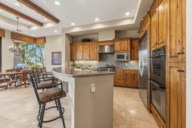 a view of kitchen with furniture and refrigerator