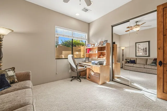 a spacious bedroom with a bed and a chandelier