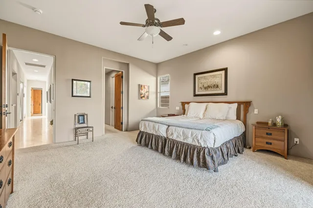 a bedroom with a bed and a large window