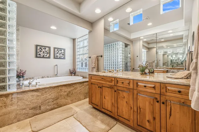 a bathroom with a granite countertop sink mirror and shower