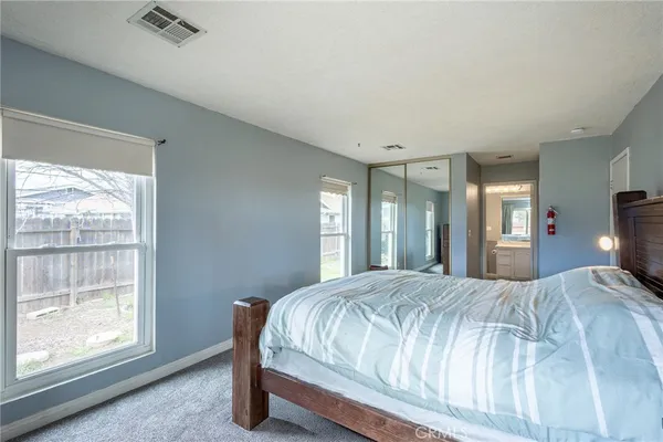 a bedroom with a large bed and a window