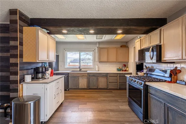 a kitchen with stainless steel appliances granite countertop a sink stove and cabinets