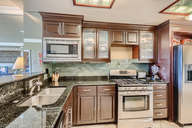 270 East Flamingo Road, Unit 315 Las Vegas, NV 89169 - Photo 5 of 11 Culinary delights await in this modern kitchen with granite counters and rich wood cabinetry.