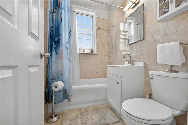 a bathroom with a toilet a sink and shower