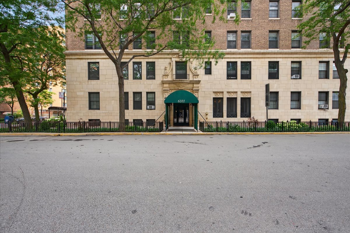 6101 North Sheridan Road, Unit 12E Chicago, IL 60660 - Photo 14 of 14 a front view of a house with a yard