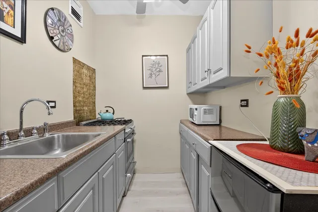 a kitchen with stainless steel appliances granite countertop a sink a stove and dishwasher