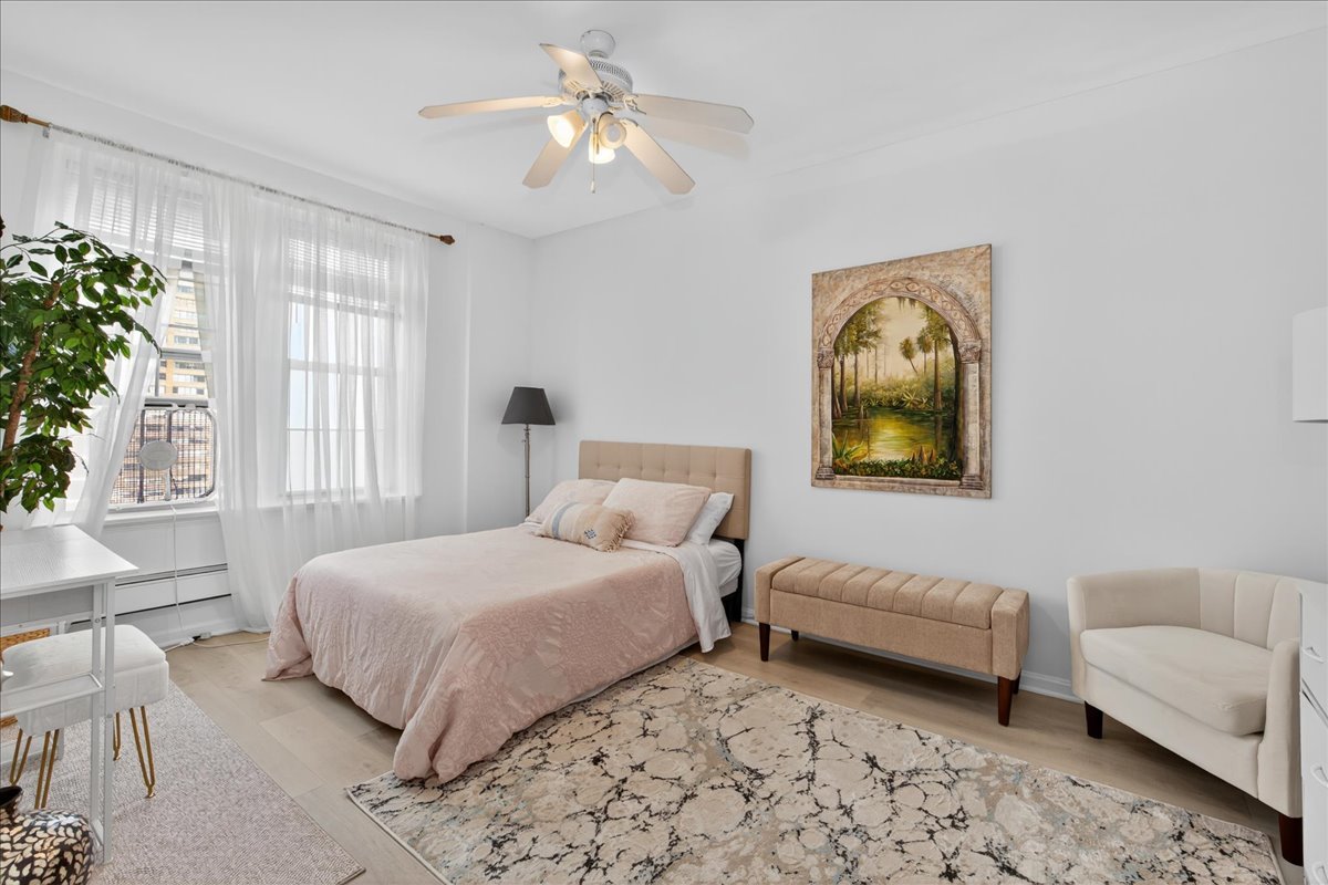 6101 North Sheridan Road, Unit 12E Chicago, IL 60660 - Photo 9 of 14 a bedroom with a bed and a couch