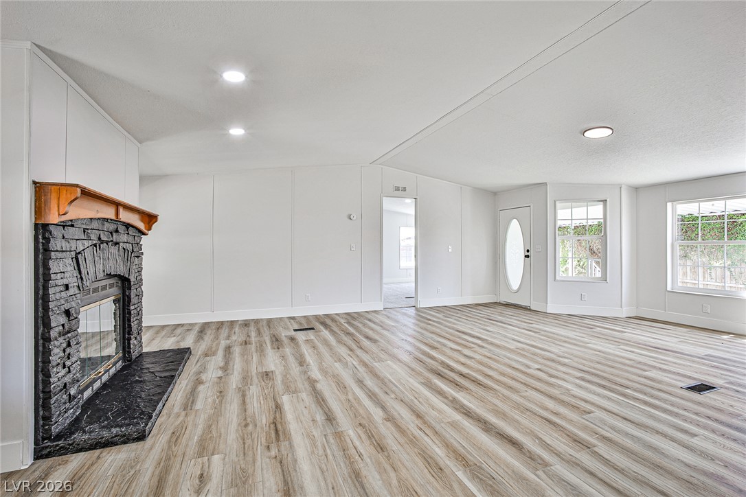 273 Aztec Lane Henderson, NV 89015 - Photo 10 of 28 A spacious living area with resilient flooring offers a welcoming fireplace feature.