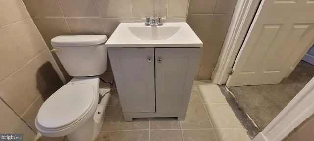 a white toilet sitting next to a white sink