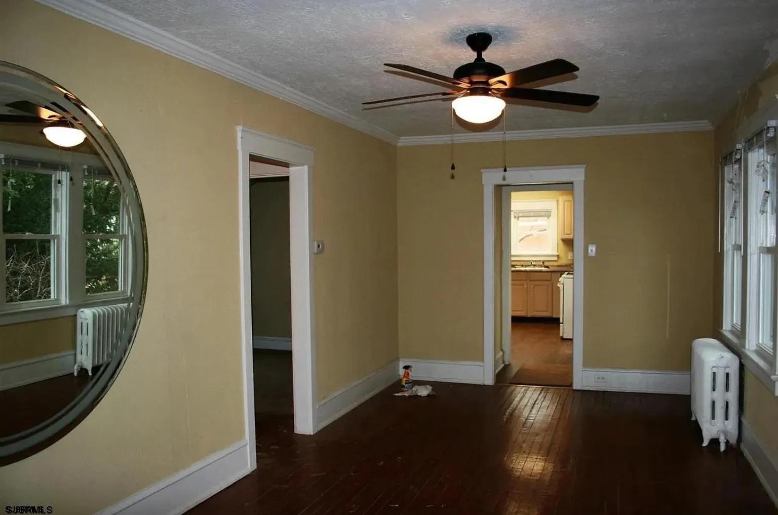 25 West Pierson Avenue Somers Point, NJ 08244 - Photo 4 of 6 wooden floor in an empty room with a window