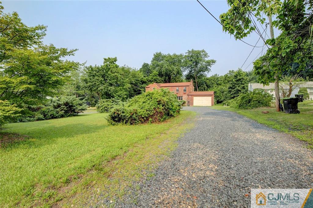 22 Cottrell Road Old Bridge, NJ 07747 - Photo 3 of 32 a view of a yard with plants and a bench