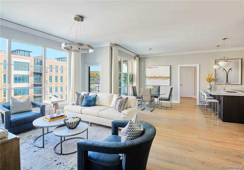 Living area with crown molding, light wood-type flooring, and a chandelier
