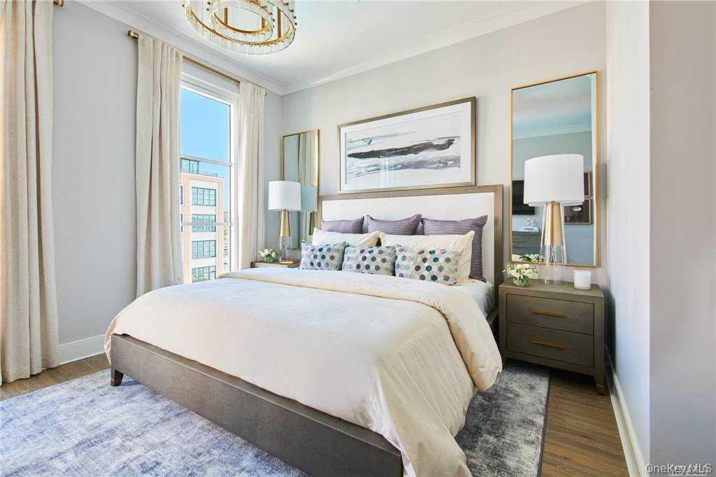 100 Garvies Point Road, Unit 1202 Glen Cove, NY 11542 - Photo 2 of 14 Bedroom featuring crown molding and wood finished floors