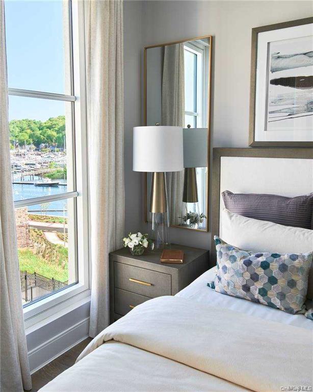 100 Garvies Point Road, Unit 1202 Glen Cove, NY 11542 - Photo 4 of 14 Bedroom featuring a water view and wood finished floors